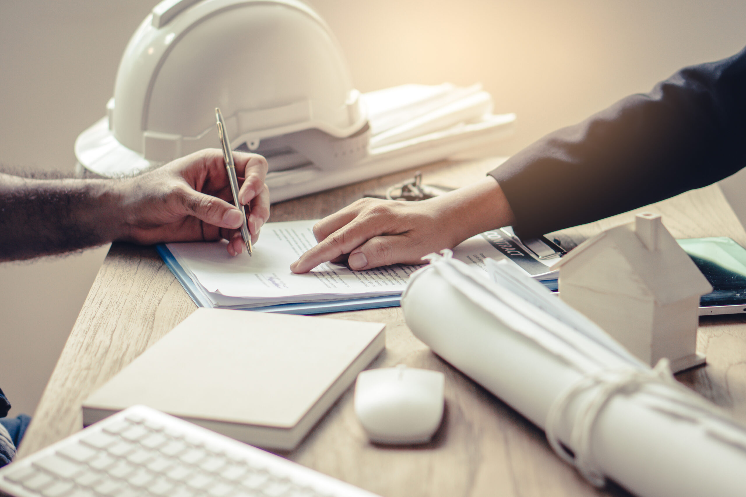 Business partners contract. Top view of close up hand of bank broker showing to client where to sign signature in contract.