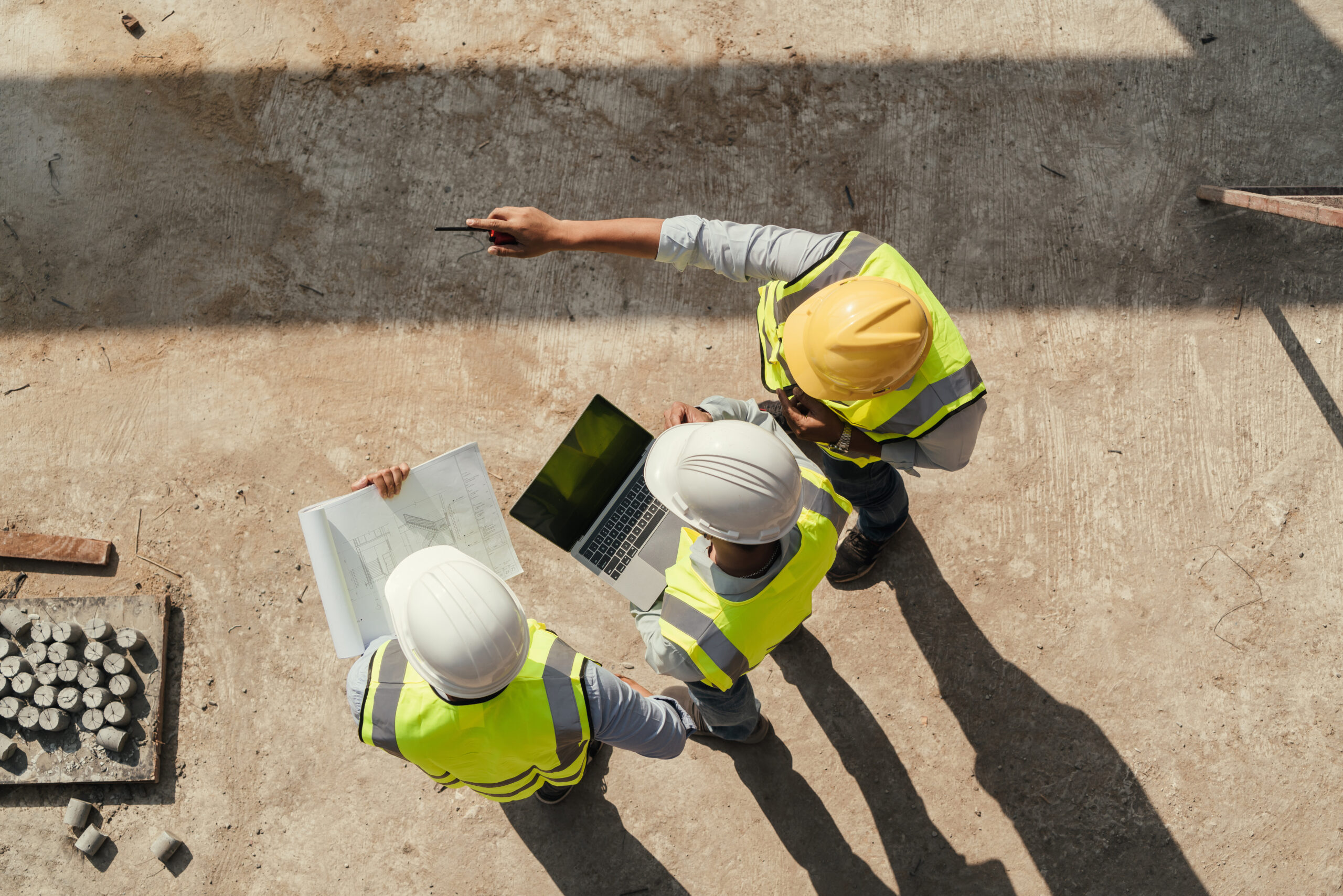 Team engineer building inspection use tablet computer and blueprint working at construction site.